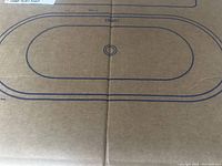 Box illustration showing oval tub outline with central drain location