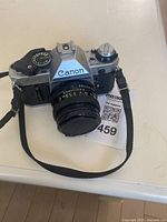Front-right angle view of Canon AE-1 Program with attached lens and strap