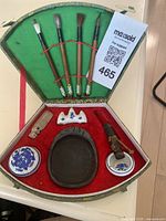 Top-down view of entire assembled calligraphy set, including five brushes, porcelain items, ink stone, seal, and case.