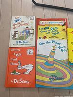 Five Dr. Seuss books laid out on the floor showing covers including 'I Am NOT Going to Get up Today!', 'Green Eggs and Ham', and 'Oh, the Places You'll Go!'