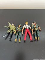 Four 1980s G.I. Joe action figures shown side-by-side on a black background.
