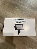 Box front showing Dewenwils LED Knuckle Flood Light label and image of the light