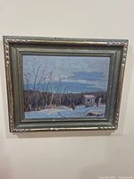 Framed oil painting on wood board, showing winter twilight landscape with trees and a house, frame scuffed.
