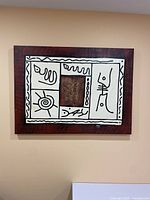 Full front view of the abstract painting hanging on a wall showing overall design, colors, and frame.