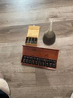 Photo showing aroma diffuser next to two decorative boxes containing essential oils bottles.