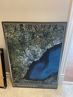 Full view of the large satellite map mounted on board, showing Toronto and surrounding areas with coastal and urban details.