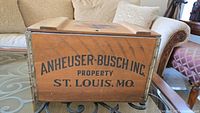 View of the side of the wooden crate marked with 'ANHEUSER-BUSCH INC. PROPERTY ST. LOUIS, MO.'