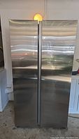 Front view of stainless steel two-door side-by-side refrigerator