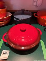 Front view of red ceramic Denby baking dish with lid