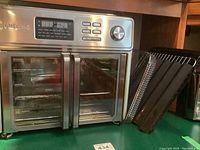 Front view of stainless steel oven with double glass doors and included trays