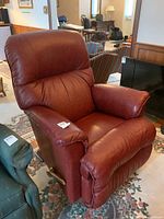 Front view of recliner in upright position, showing seat cushions, armrests and overall condition