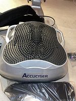 Close-up of silver Accuciser base and textured rubber-nub footplate with side handles