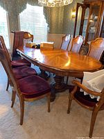 Full dining set with table, leaf installed, eight chairs arranged