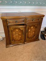 Full front view showing two drawers above two lower doors with inlay