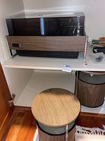 Overall view of Zenith turntable with dust cover and two drum-shaped speakers on shelves
