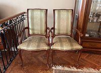 Front view of both chairs side by side showing upholstery and wood frame