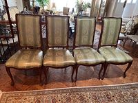 Front view of four dining chairs in a row.