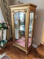 Front view showing single glass shelf, mirrored back and velvet base