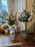 Full view of Asian style ceramic vase with faux flowers and handmade ceramic planter with faux rose bush, showing height and details of flowers and containers.