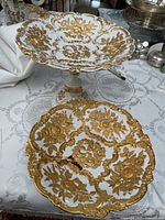 Combined view of porcelain compote and scalloped bowl; red stain visible on bowl interior