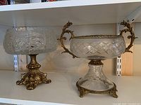 Overview of both crystal bowls on white shelf