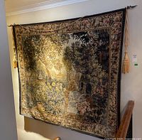 Full front view of tapestry hanging on wall with tassel