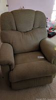 Front view of the beige fabric La-Z-Boy recliner rocking chair showing padded arms and segmented cushioned back.
