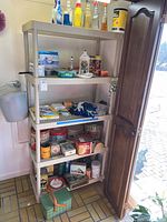Full view of the five tier shelving with various household items placed on shelves to show scale and condition.