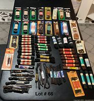 Top view showing many vintage shoe lace packages and tied sets arranged on black surface.