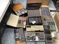 Top view of multiple boxes filled with assorted music cassettes and 8-track tapes with visible wear.