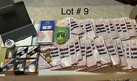 Lot overview showing multiple items including Slim Folio Pro box, pantyhose packs, bath and health products, UV sanitizer, and sports bandages