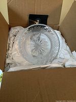Open view of boxed crystal bowl with original packaging and tissue paper.