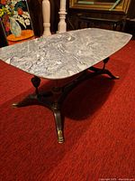 Side view showing marbled granite top and wooden base