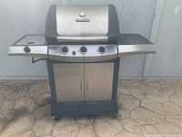 Front view of the Char-Broil gas BBQ grill showing the full unit with side burner, control panel, and storage cabinet.