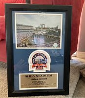 Full view of the framed Shea Stadium memorabilia with photo of stadium, logo patch, and commemorative plaque.