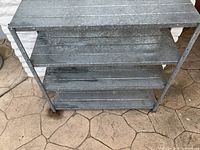 Top angled view of the metal work bench showing shelves detail and metal construction.