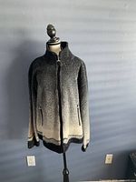 Front view of wool zip jacket on a mannequin showing gradient color and zippered pockets.