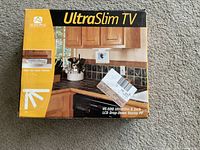 Box showing Audiovox UltraSlim TV model VE-500 with product image and branding.