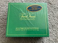 Sealed green box labeled Trivial Pursuit All-Star Sports Edition subsidiary card set.