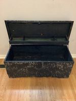 View of open storage chest showing internal compartments and organizer tray.