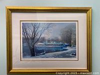 Framed signed serigraph print depicting Loeb Boathouse in winter with snow and trees.