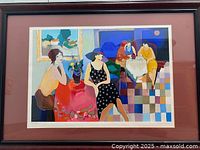 Frontal view of the framed serigraph showing the vibrant scene of women in a cafe setting with colorful geometric floor patterns.