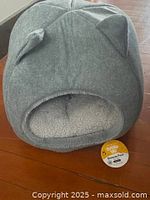 Front view of the grey cat bed showing cat ear design and fleece interior.