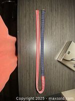 Photo showing the full length of the fabric belt with red and white stripes and blue with white stars pattern