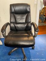 Front view of the black high back office chair showing cushioned seat and backrest with padded armrests.