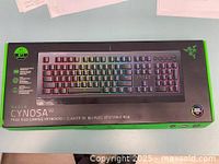 Box of Razer Cynosa V2 True RGB Gaming Keyboard showing front with branding and model.