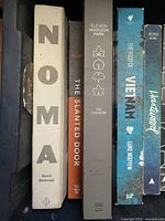 Photo showing cookbooks NOMA, The Slanted Door, Eleven Madison Park, The Food of Vietnam, Hartwood.