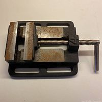 Top view of the solid metal bench vice showing the screw handle and clamping jaws.