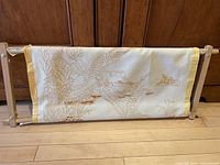 Full view of wooden adjustable tapestry frame with attached canvas showing ducks in flight design