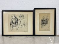 Two framed Charles Bragg etching prints side by side against white wall, one of an elderly man’s face, the other of two children sitting.